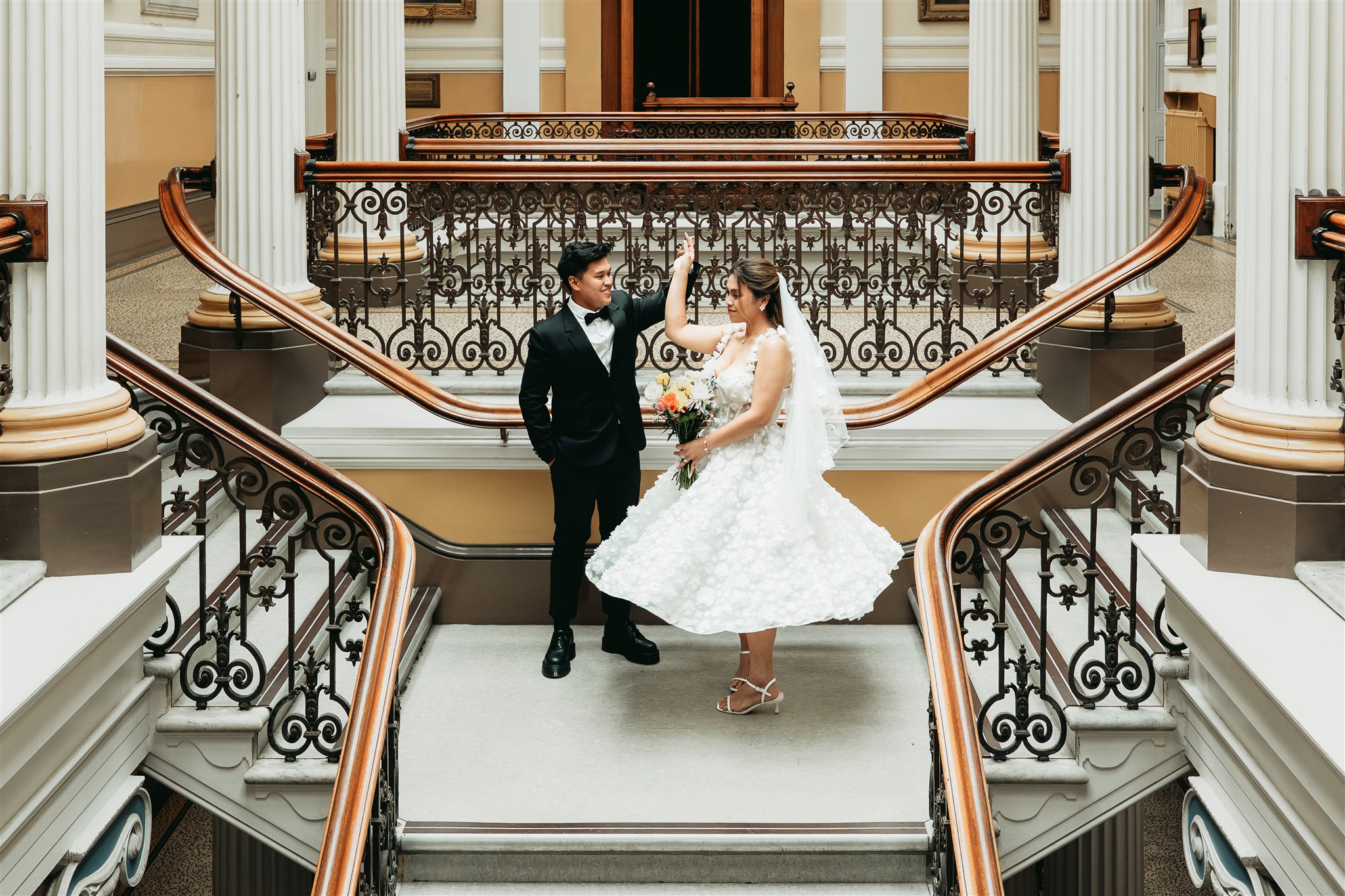 Newlyweds dance on the Town Hall stairs after their Brighton Town Hall wedding
