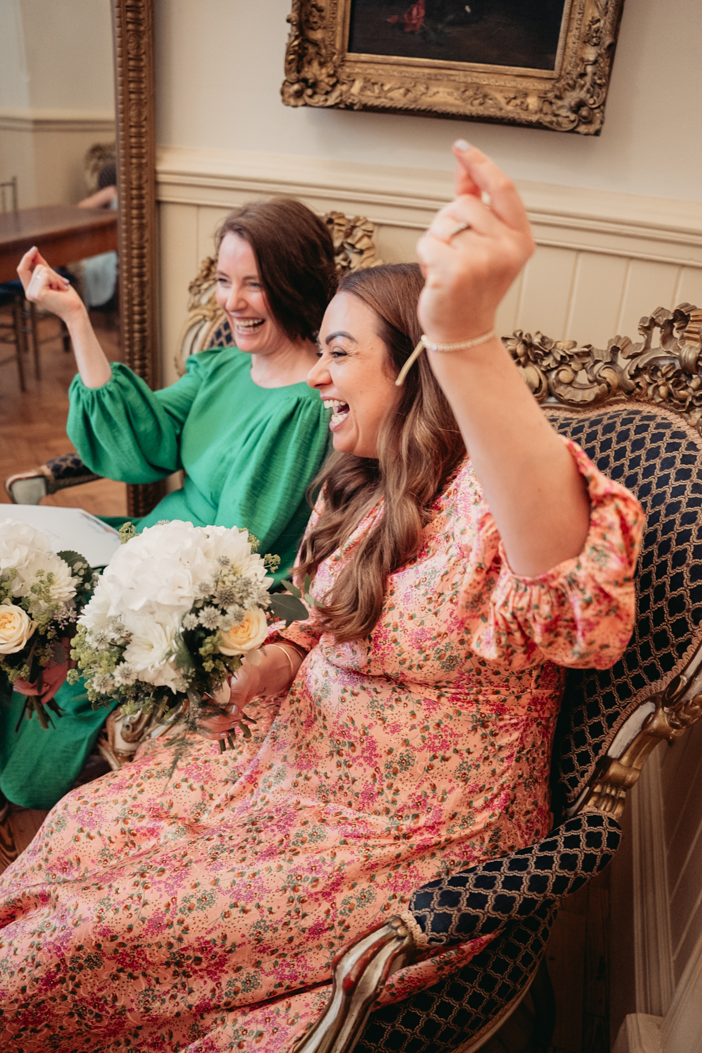 Bridesmaids in green and pink celebrating inside the Floral Room at Brighton Town Hall
