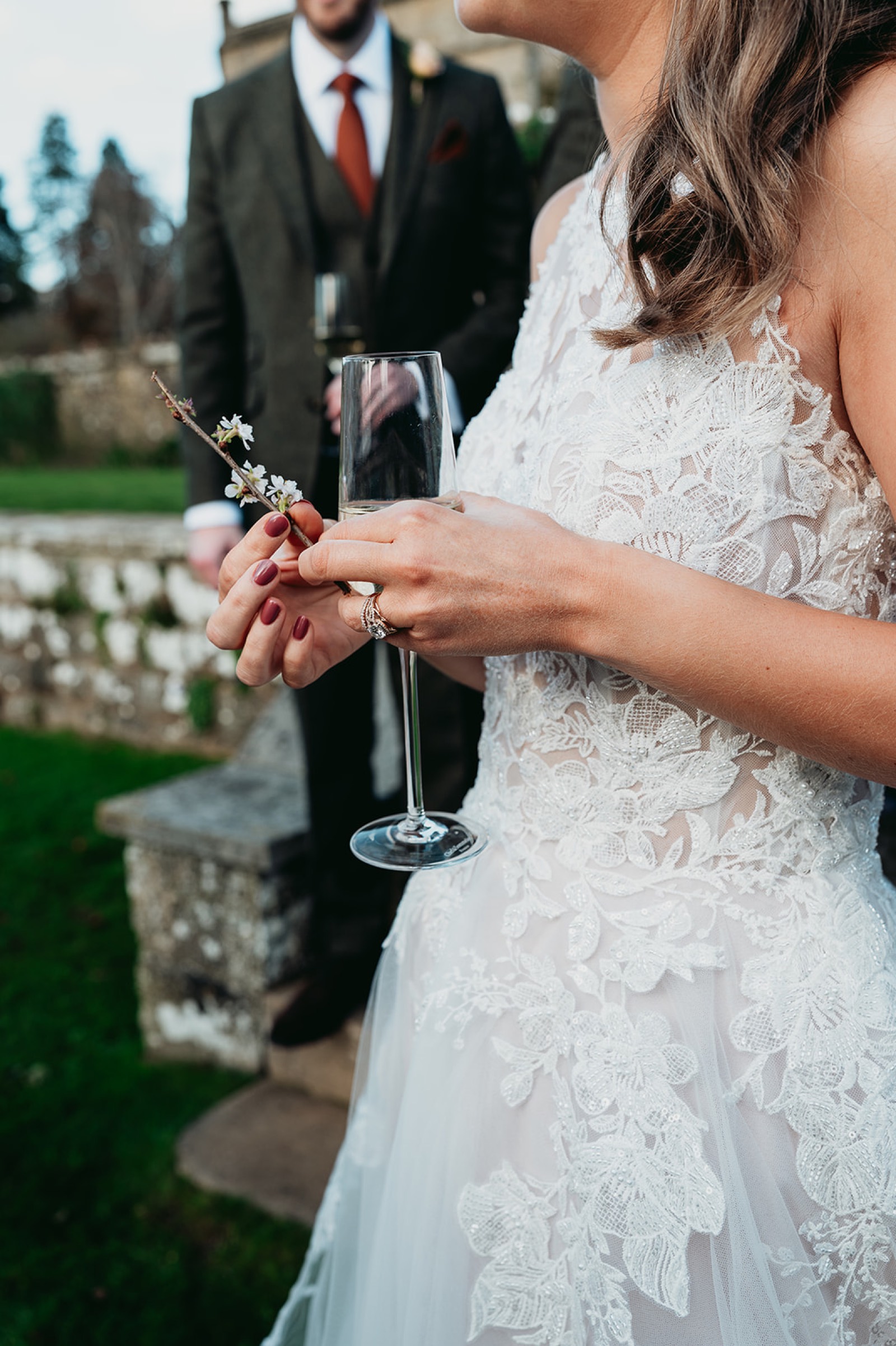 Bride holding a glass of champagne after the ceremony