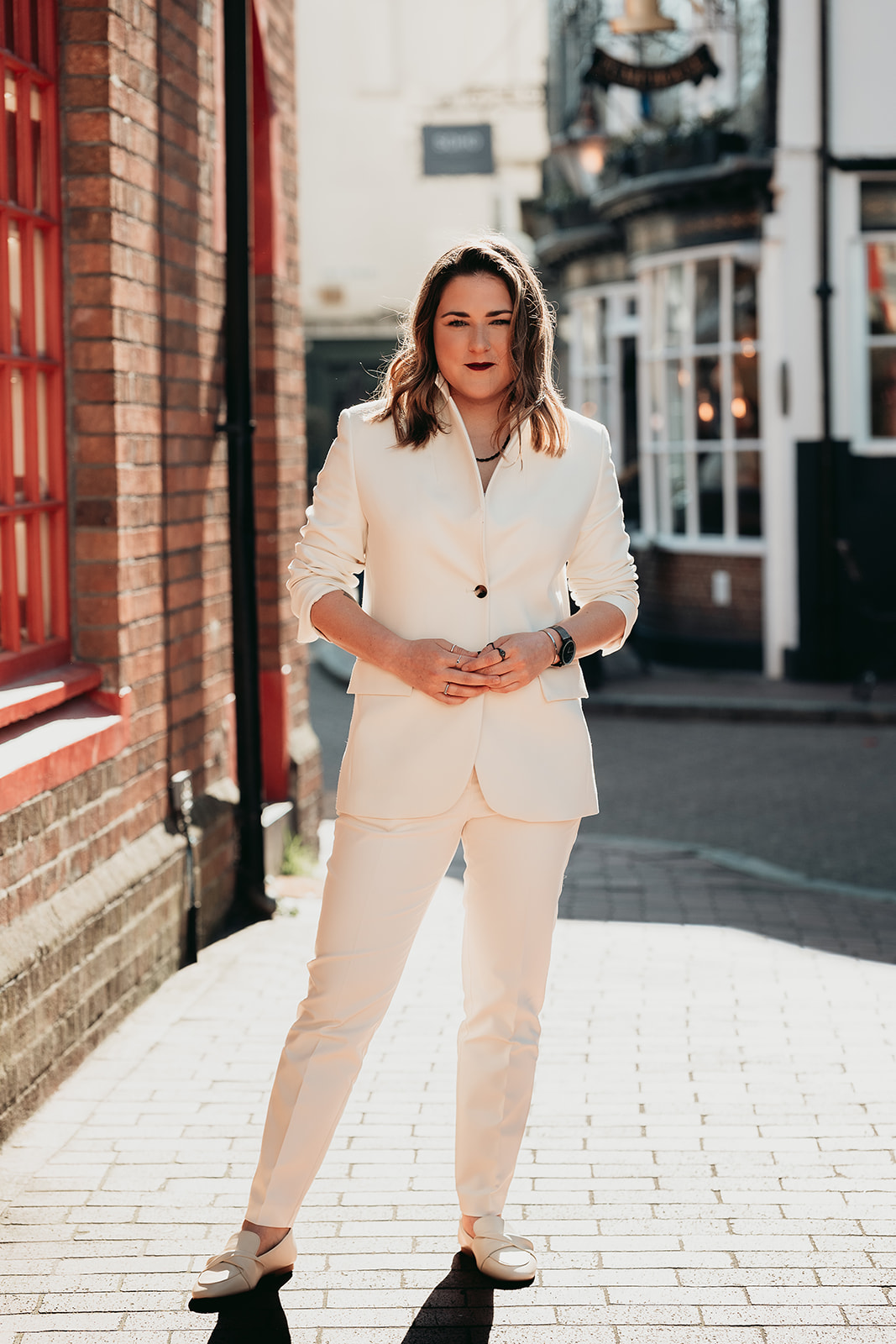 A bride photographed in a white wedding suit in Brighton’s Lanes
