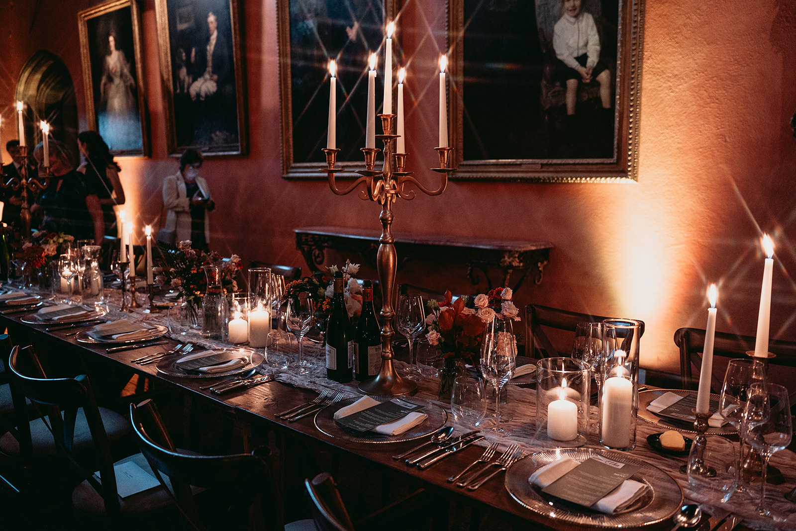 Winter wedding reception tables decorated with seasonal flowers at Cowdray House