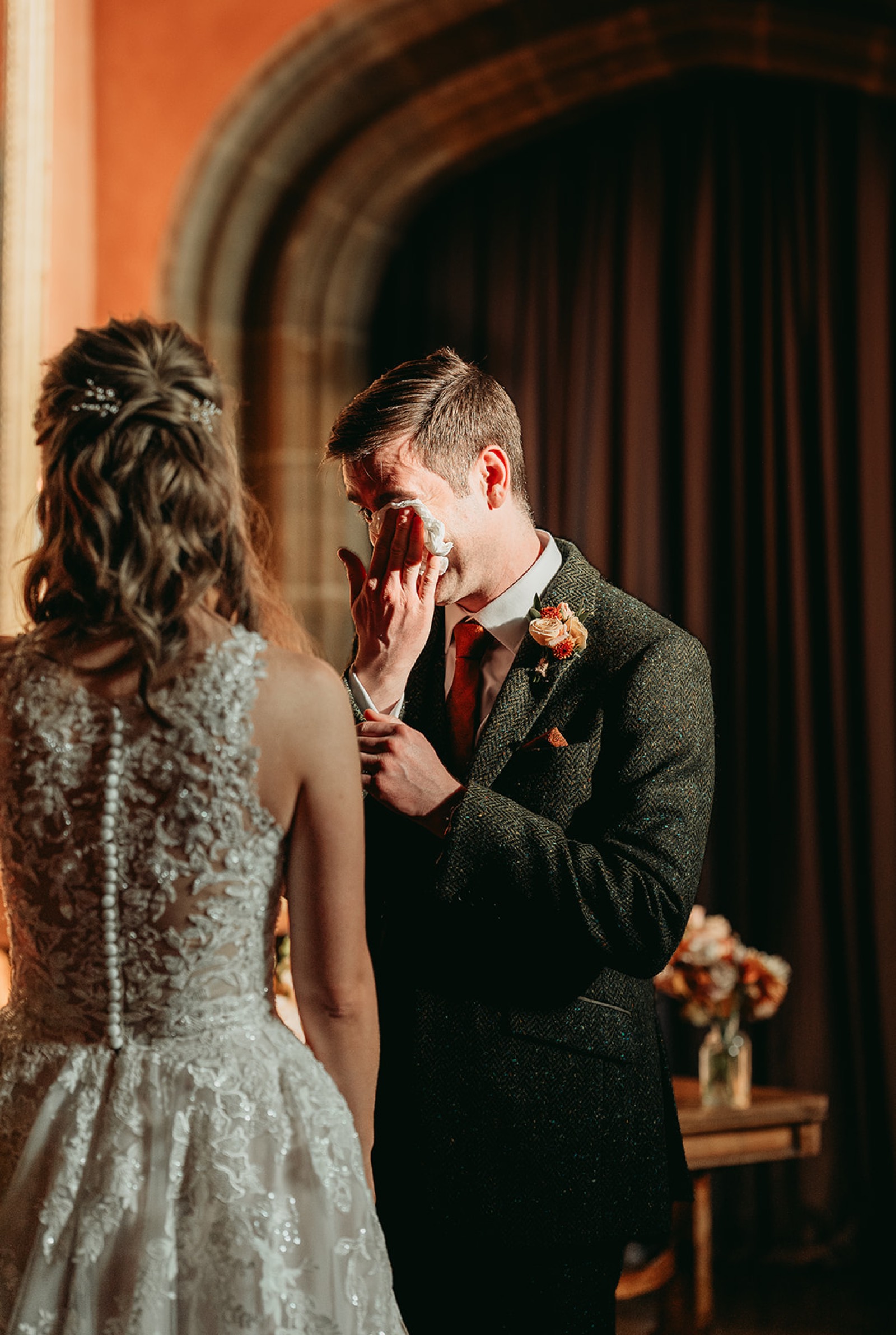 Groom wiping away a tear during the ceremony