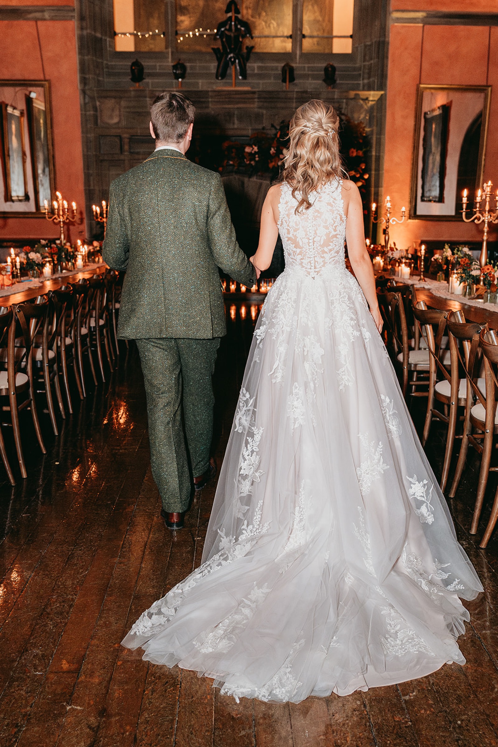 Newlyweds entering their candlelit wedding reception