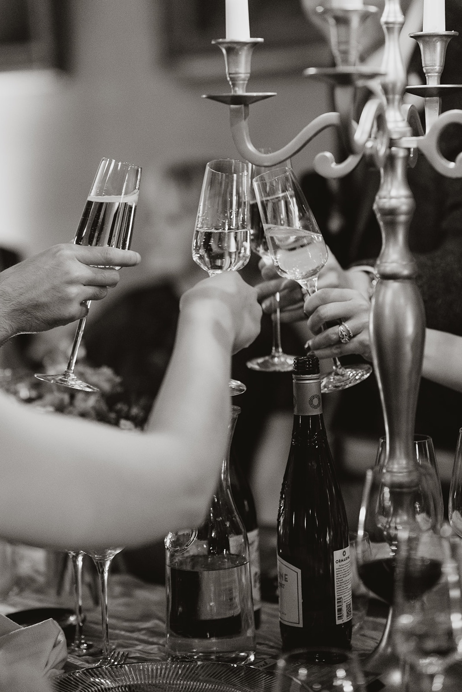 Hands raised in a toast during the evening wedding speeches