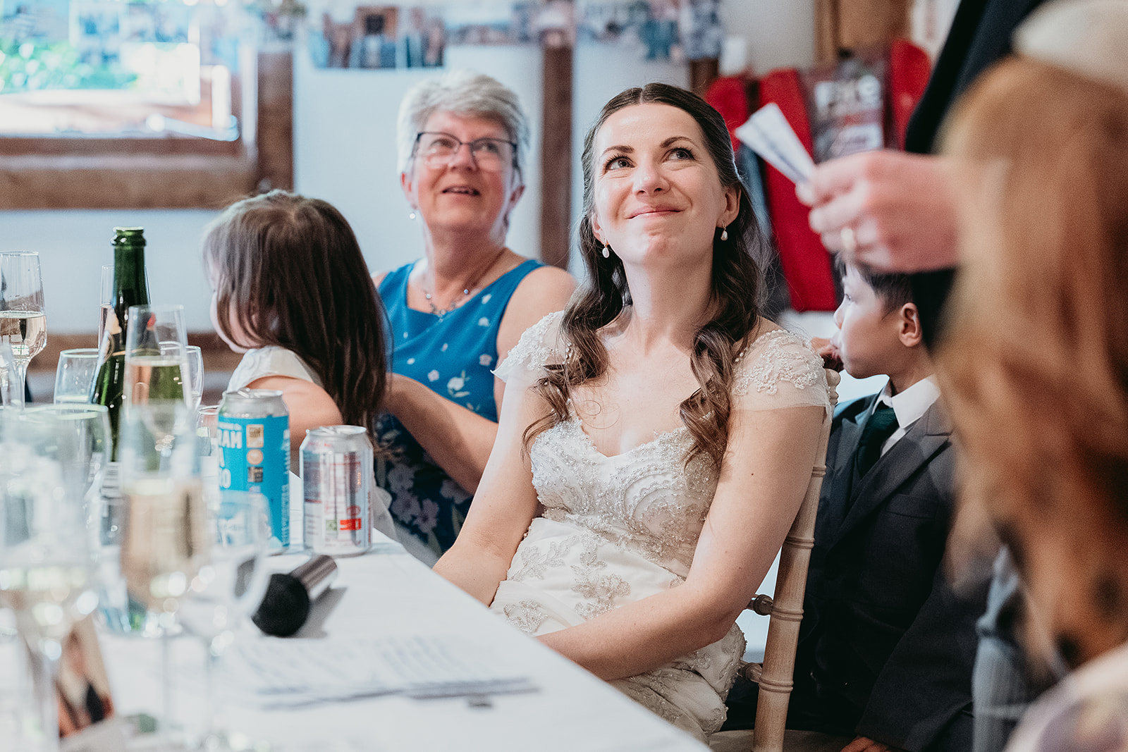 Guests cheering during the wedding speeches at Fitzleroi Barn