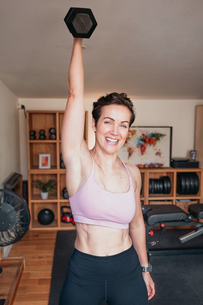 Personal trainer Belinda Moody lifting a dumbbell during a Sussex fitness branding shoot
