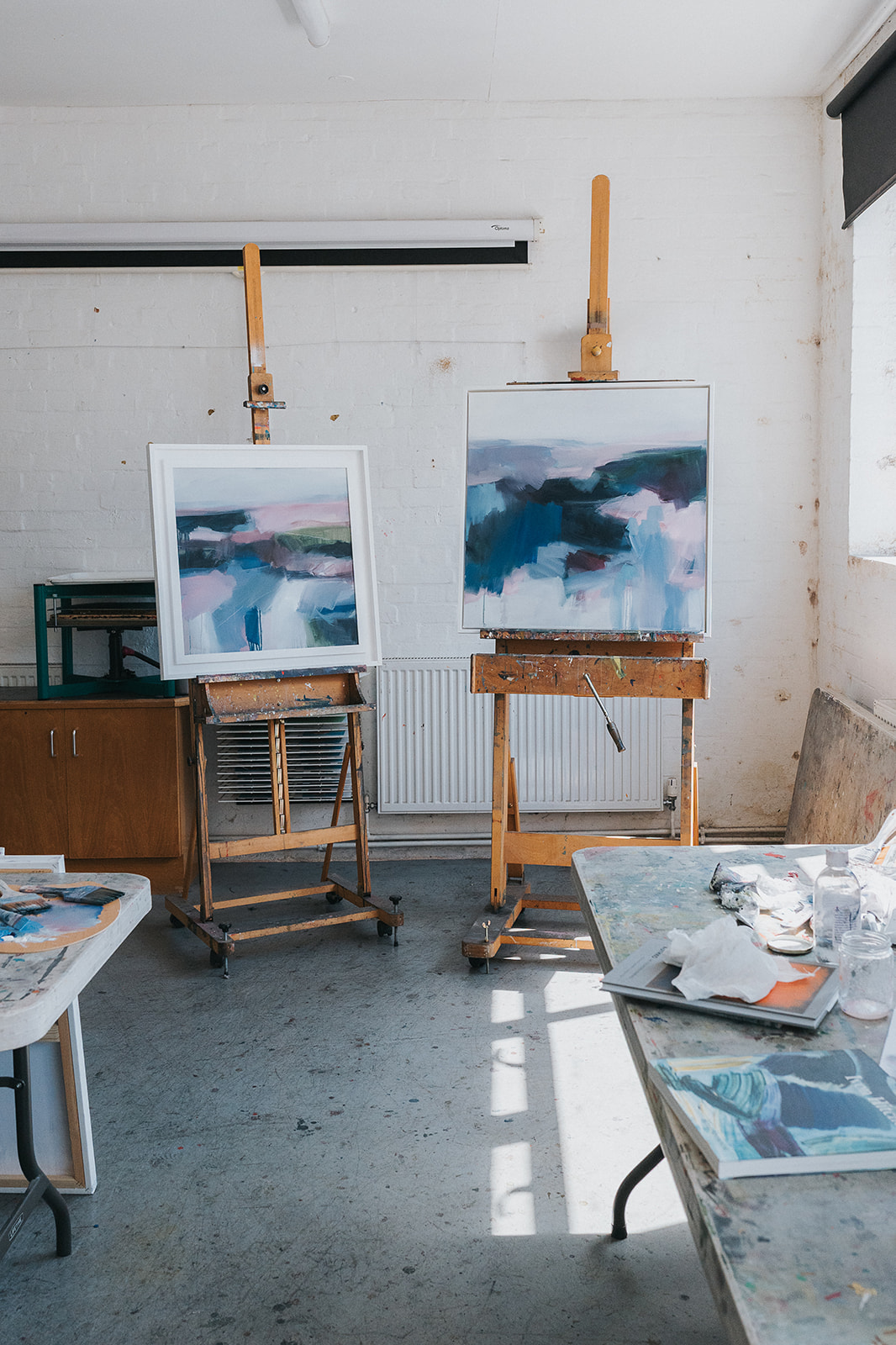 Paintings and easels in Lucy Beale's art studio