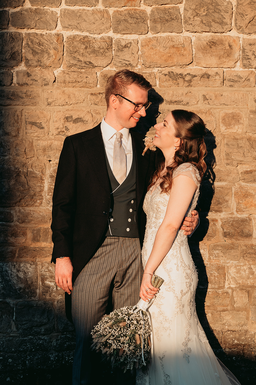 Jodie and Jordan in evening light beside the stone barn at Fitzleroi in West Sussex